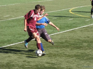 Junior Captain Jeffery Schwartz tackling opponent for possession over the ball.